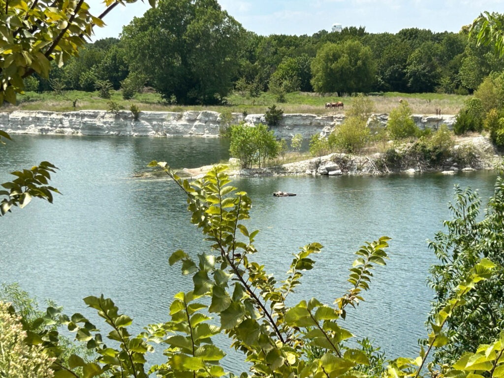 Limestone bluffs and calm water at the Phillips Quarry Park site – existing conditions documented for parks planning by Urban Alchemy Collective