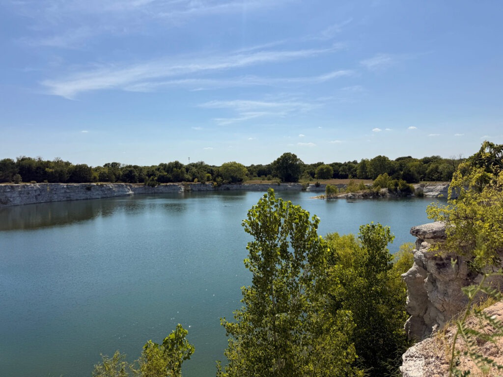 Rock outcroppings and native trees along the quarry lake at Phillips Quarry Park – landscape architecture site study by Urban Alchemy Collective