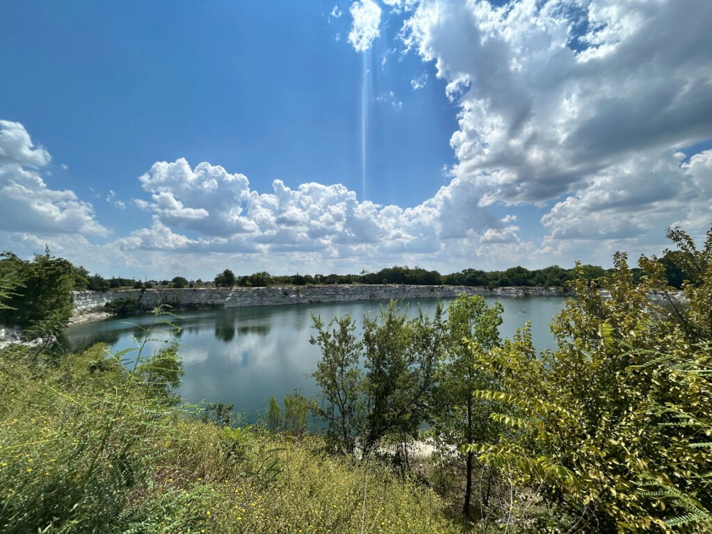 Quarry lake with limestone cliffs at the Phillips Quarry Park site – site analysis for parks planning by Urban Alchemy Collective